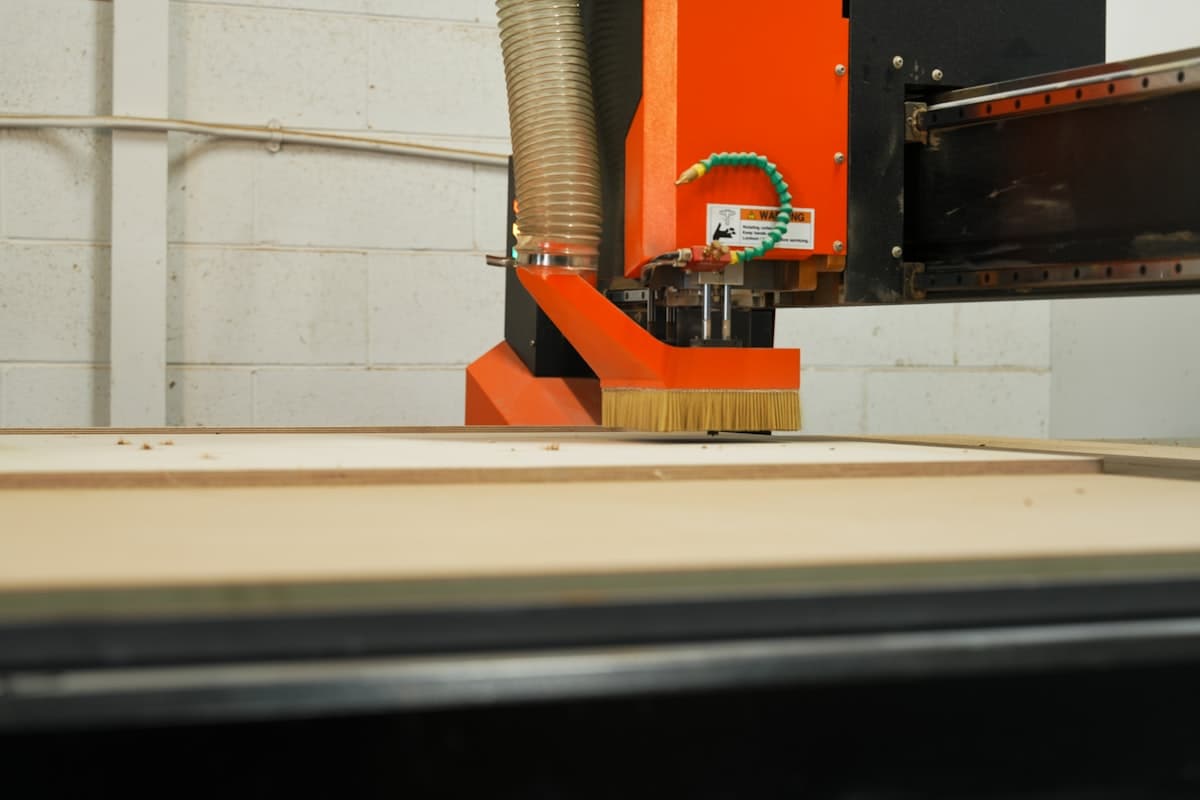 CNC machine cutting a wood panel