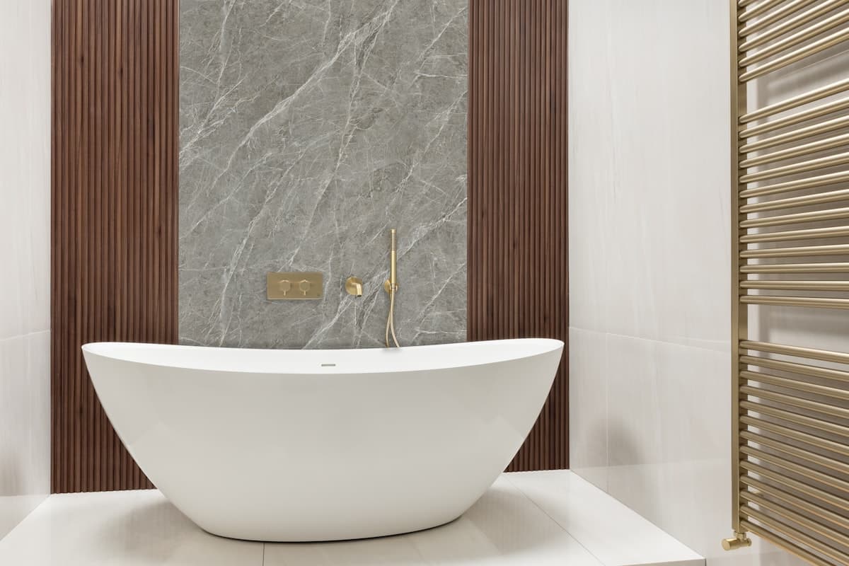 Modern bathroom with freestanding tub and brass fixtures